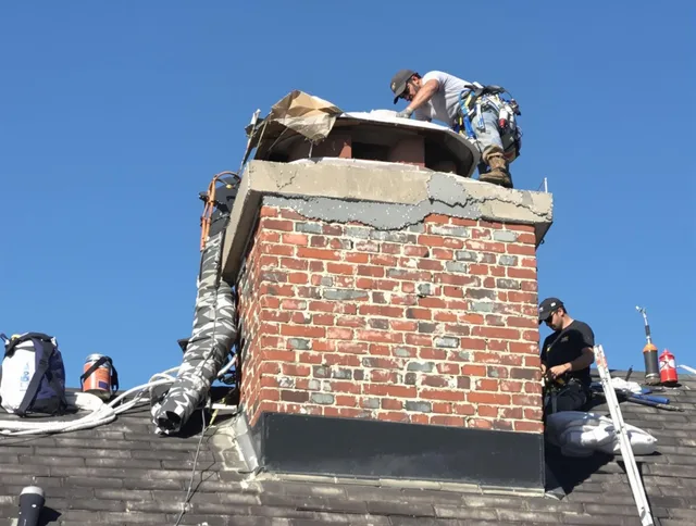 Lincoln Chimney Sweep installing a custom chimney crown in Lincoln, RI