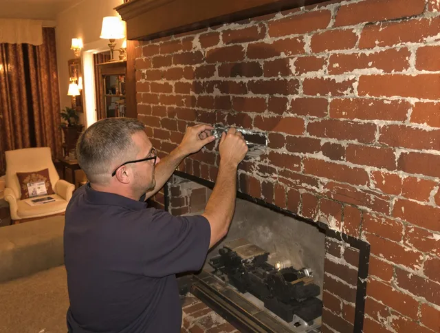 Lincoln Chimney Sweep expert fixing a fireplace in Lincoln, RI